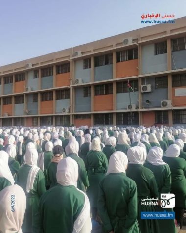 Outdoor prayer gathering by school in Jordan