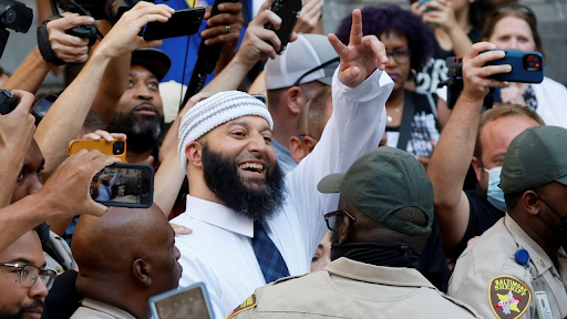 Adnan Syed celebrates as he leaves the courthouse.