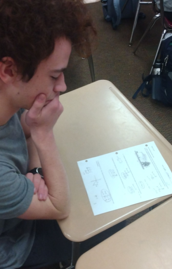 Laim,a SPASH student, looking at his Pre-calc quiz.