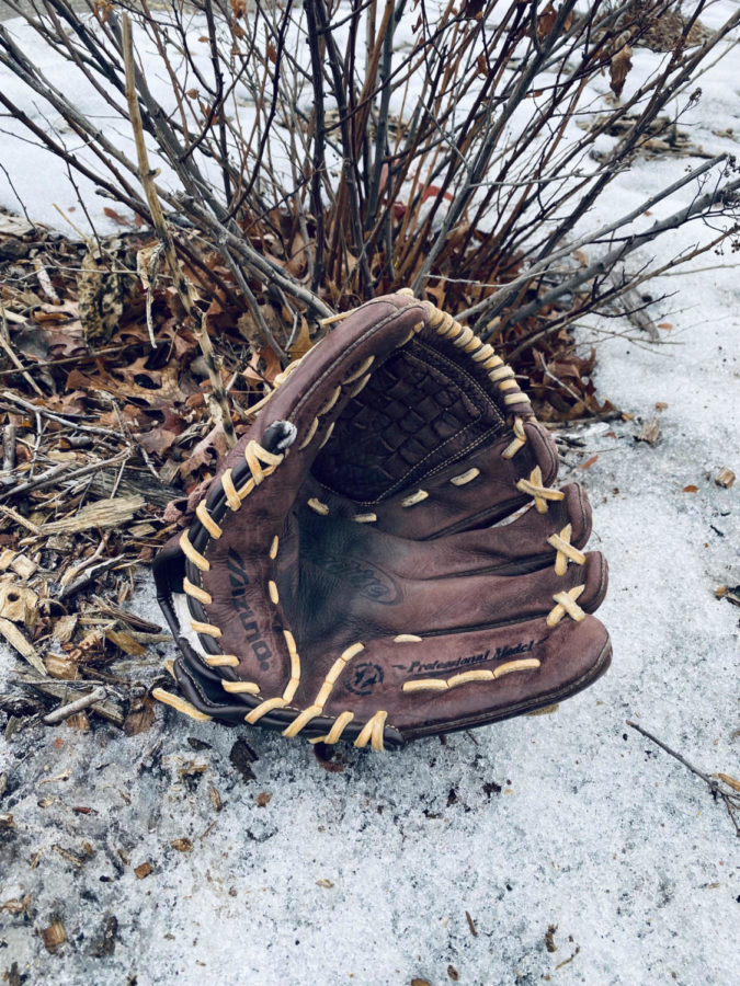 Photo of a softball glove on the ground, by Hanah Netys outside of SPASH.
