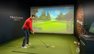 This is an image of a man using a golf simulator posted by Northway Golf Center.