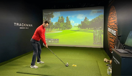This is an image of a man using a golf simulator posted by Northway Golf Center.